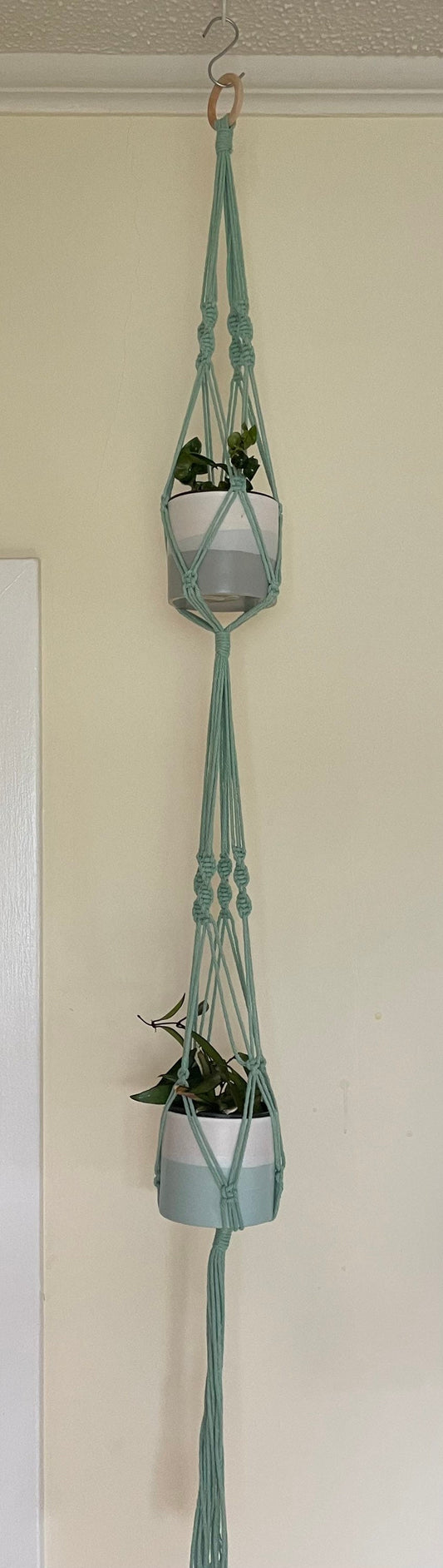 Macrame double plant hanger in mint green.